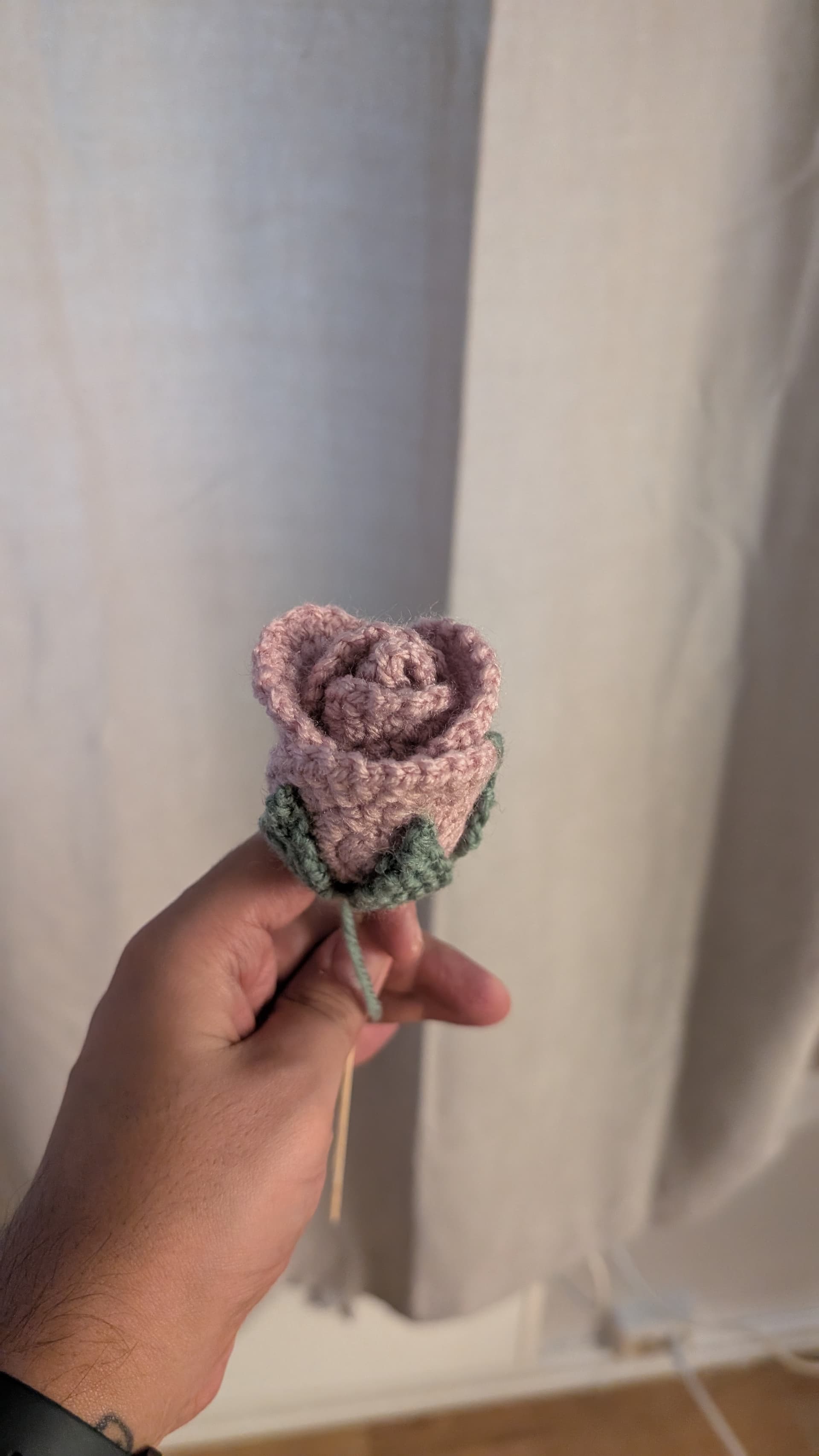 White crocheted flowers beside a window